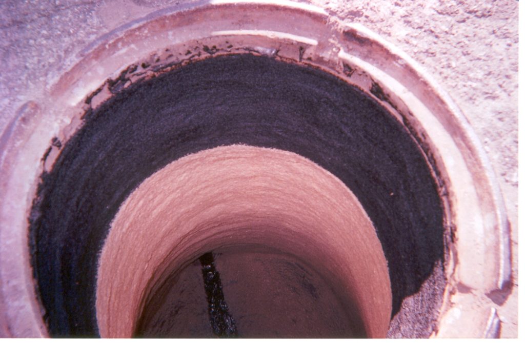 This photo shows the interior of a manhole structure where an F-88 application has been used to create a smooth, uniform lining.