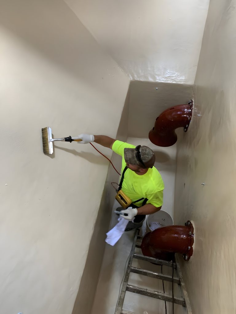 high voltage spark testing being preformed in a wastewater structure 
